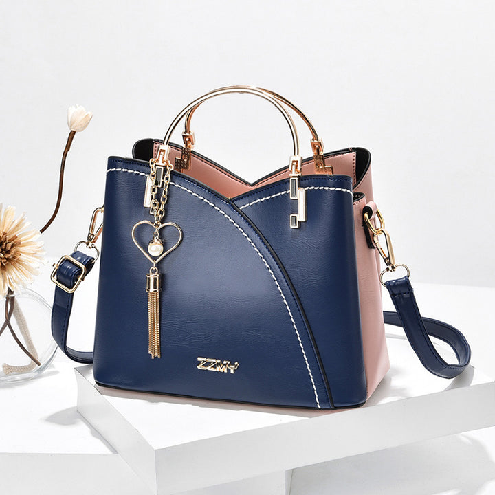 Color block handbag with heart tassel