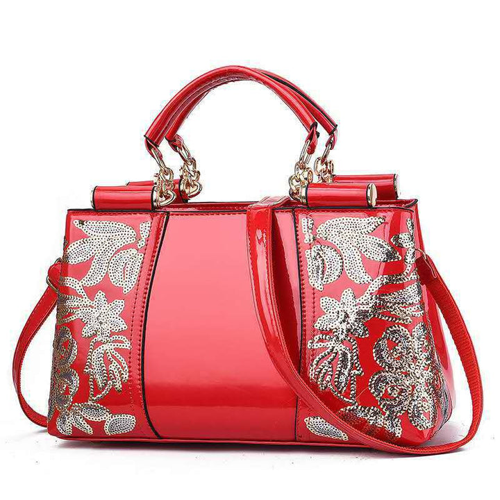 Sequin embroidered patent leather handbag