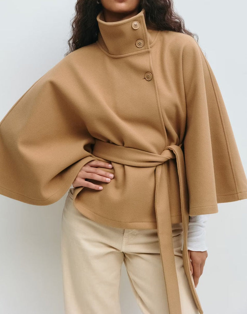 Woman in belted cape coat with high collar