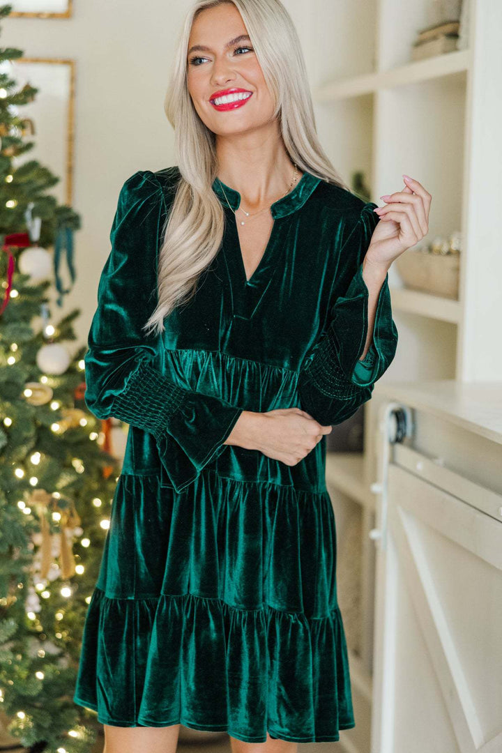 Woman in a green velvet mini dress