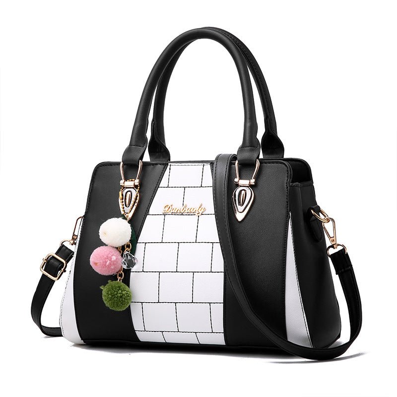 Two-tone handbag with pompom charm